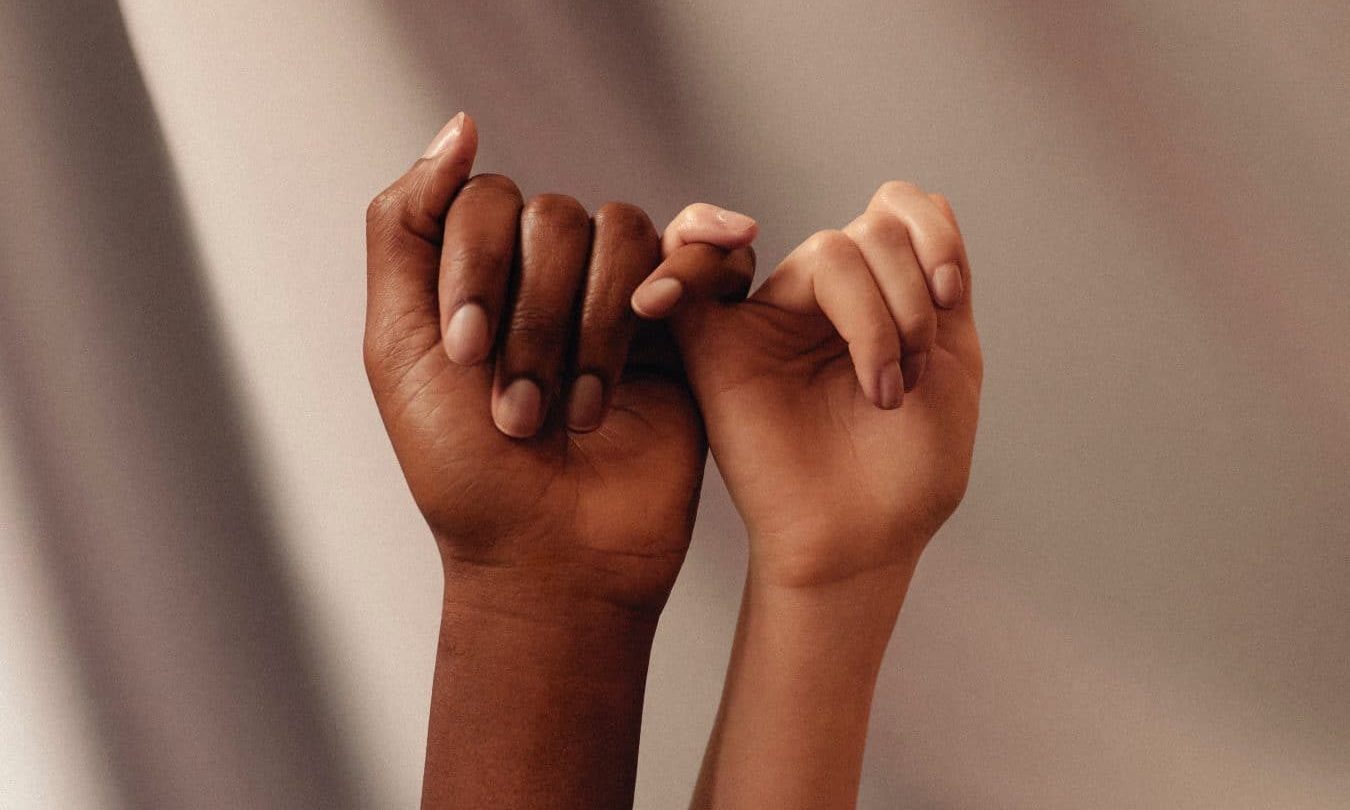 persons hand with white manicure