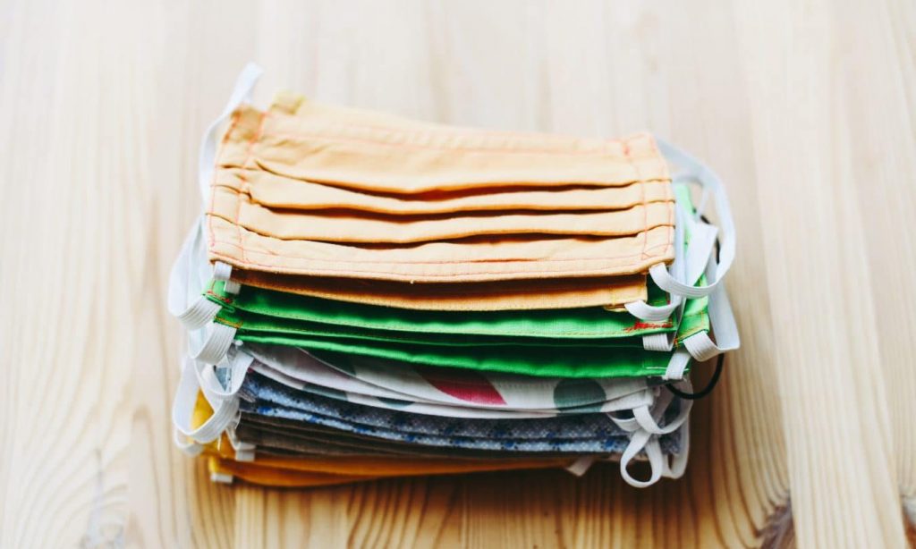 stack of white yellow green and blue textiles