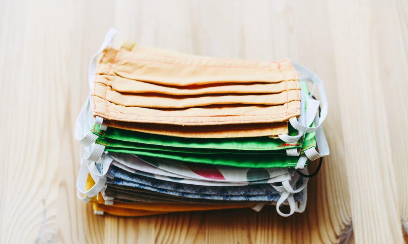 stack of white yellow green and blue textiles