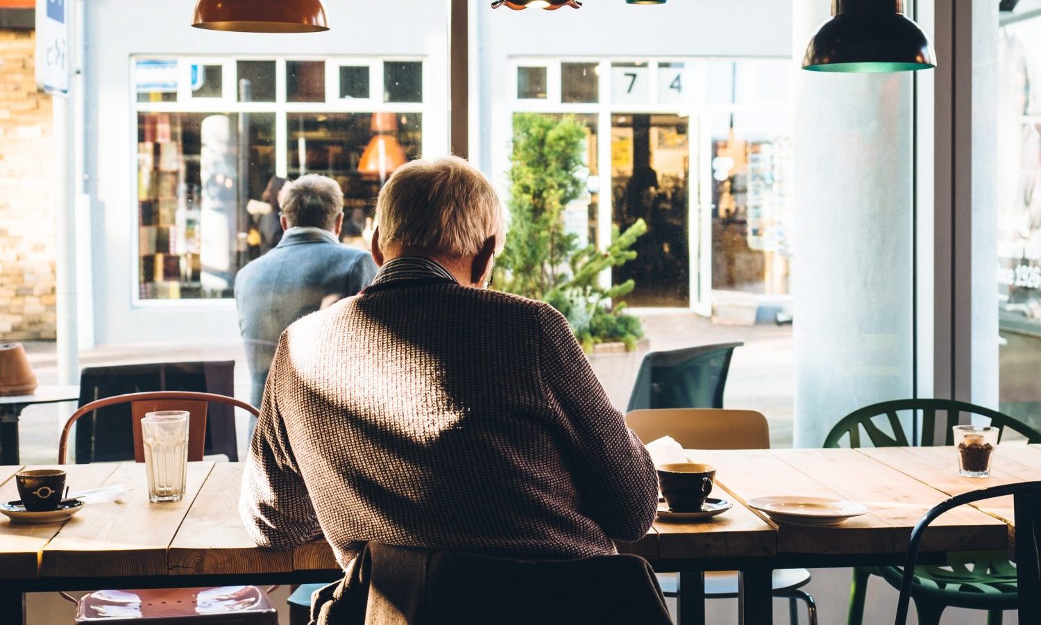 man in chair with table beside coffee