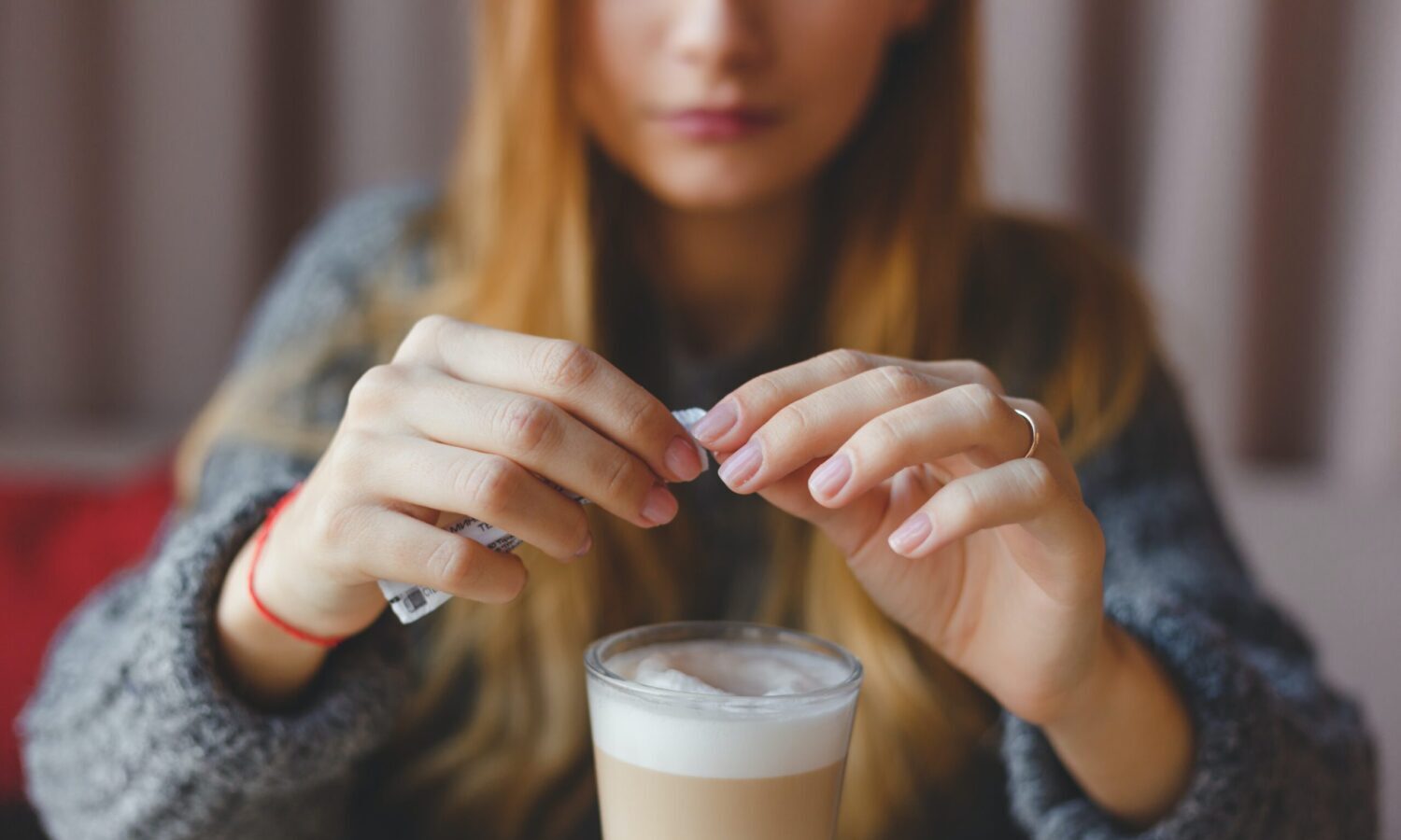 putting sugar in coffee