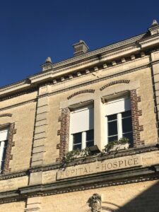 a building with two windows and a sign that says hospital hospital