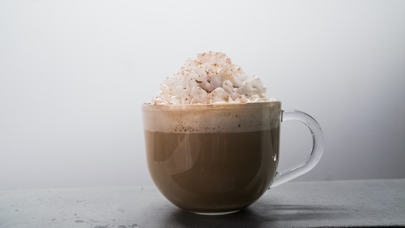 brown ceramic mug with white flower