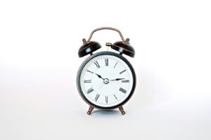 round black and white analog alarm clock